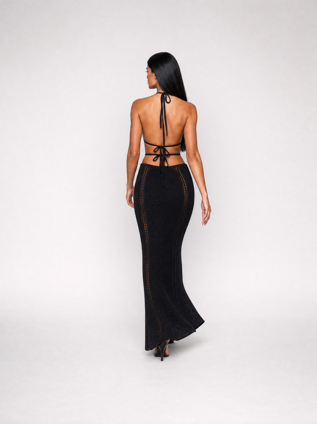 Delphine halter maxi dress in black, back view walking